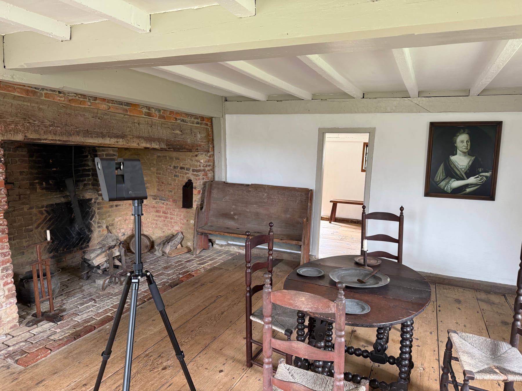 LiDAR scanner set up beside the keeping-room fireplace inside the Jethro Coffin House